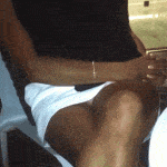 Uncrossing her tanned leg in white mini skirt pantyless