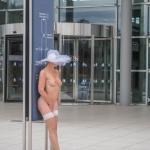 Nude in white hat stockings and high heels