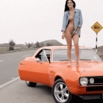 Nude on car bonnet looking for a ride