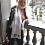 Blonde MILF side boob flashing on balcony