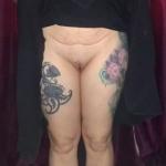 Inked mature woman pulling up skirt and flashing bald cunt