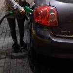 Fueling the car and flashing big tits