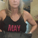 Mature lady flashing firm tits with a smile