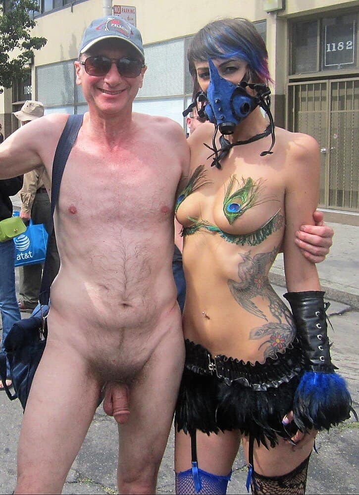 Real Amateurs Public Nudity Pics  : Naked man flasher exhibitionist Brucie caught exposing his penis nude in public with sexy girl, San Francisco Folsom Street Fair, BDSM, amateur CFNM Sexy girl with nudist Brucie Folsom Street Fair CFNM