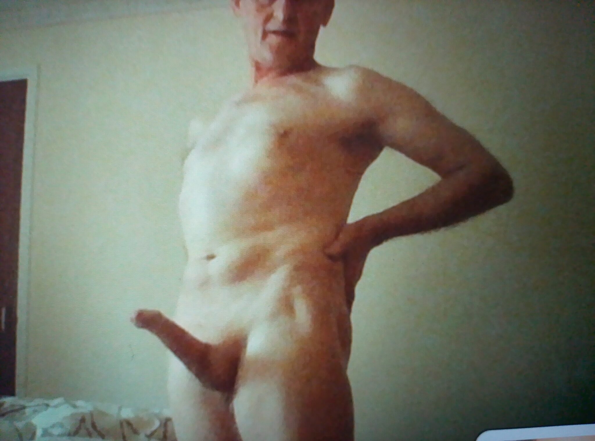 oily nyaash pants pono - Teasing Thrusts in the Bedroom A man stands confidently in a dimly lit bedroom, his upper body exposed, hinting at a power dynamic through his posture and gaze. - Real Amateurs