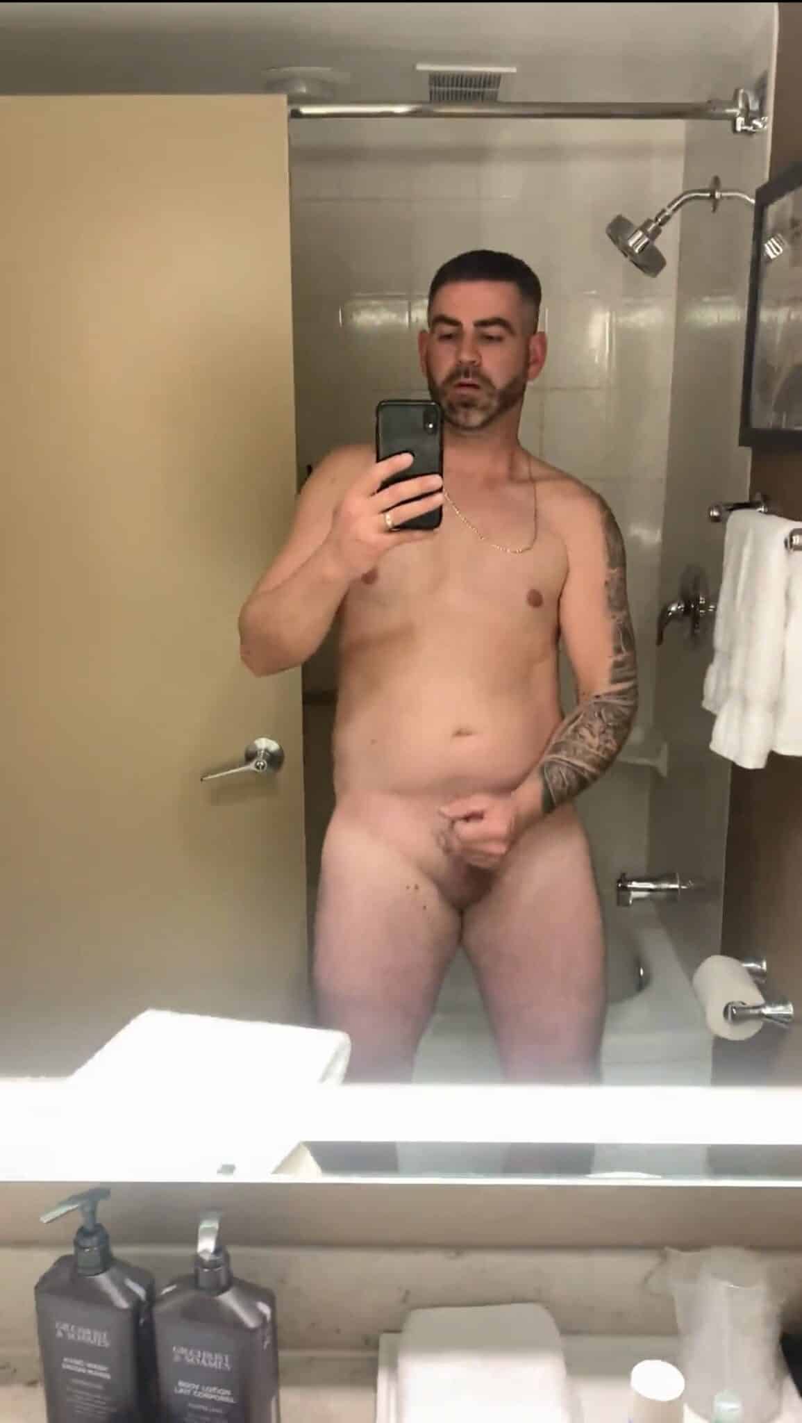 Dick Flash Pics: Bathroom Mirror Selfie: Hairy Balls and Soft Cock A man takes a mirror selfie in a bathroom, showcasing his nude body with a focus on his hairy balls and soft cock. The image captures a neutral, slightly ser...