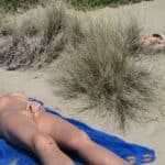 Beach Bliss: Naked Couple Basking in Public