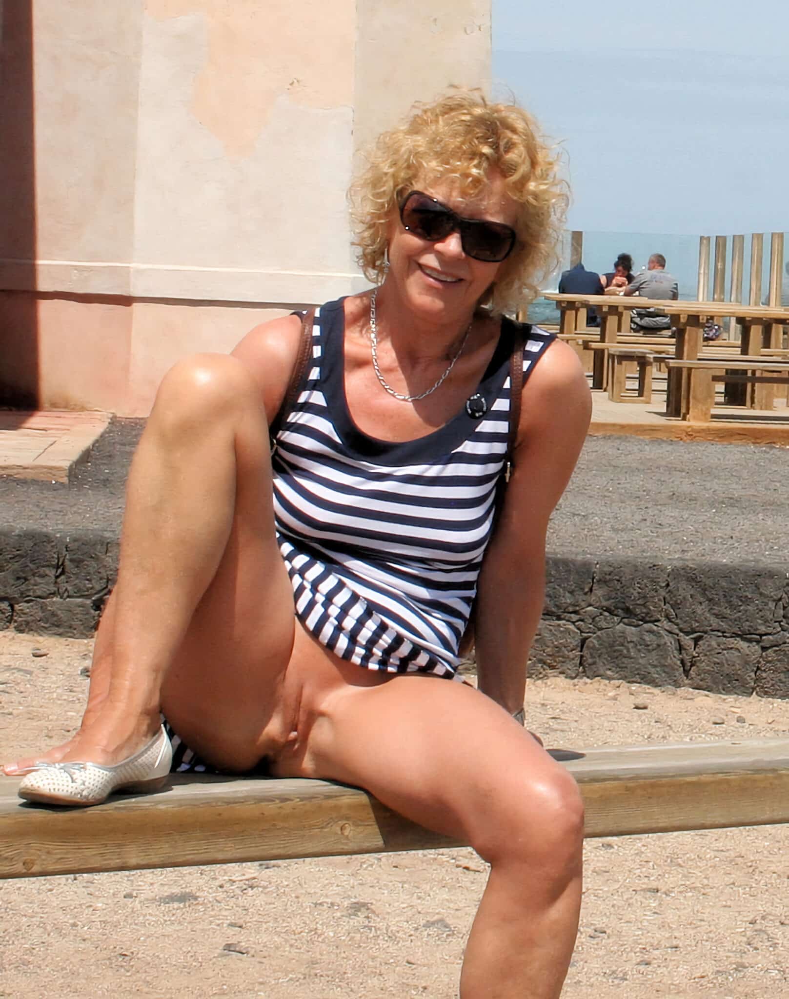 milf bent over - Public Tease: MILF Flashes in Striped Tankini A MILF in a striped tankini teases onlookers in a public square, her confident stance and revealing outfit drawing attention. - Hotwife Pics