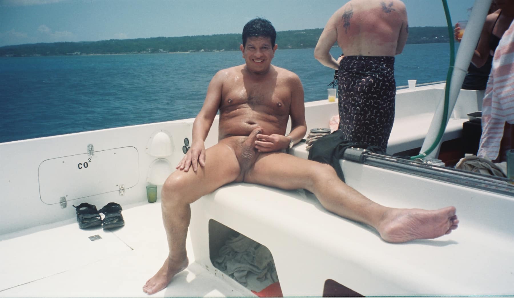 public flash nude - Can You Spot the Semi-Hard Cock on This Naked Cruise? Two men on a boat, partially nude, flash their bodies with confidence. One shows a semi-hard cock, the other reveals an ass crack, enjoying the freedom of pu... - Dick Flash Pics