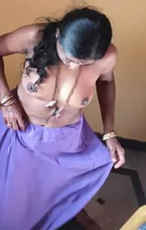 Bitch Flashing Pics: Midday Flash: Curvy Aunty’s Bedroom Tease Curvy South Asian woman topless in bedroom, skirt pulled aside, breasts exposed, no explicit activity visible.