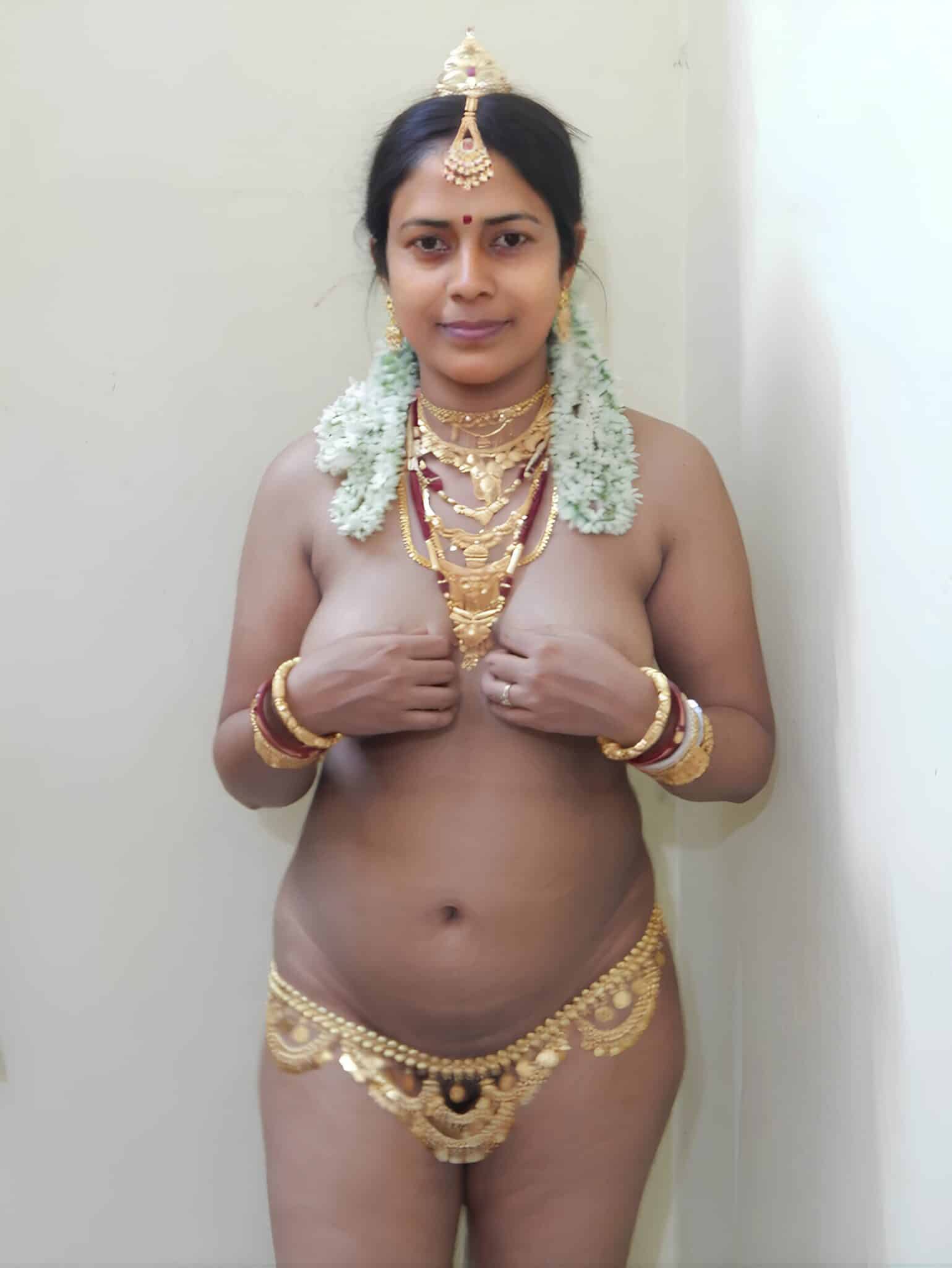 milf see thru - Why Does This MILF Flash Her Boobs in Gold Jewelry? A MILF in gold jewelry flashes her boobs, hands covering her chest, in a plain indoor setting. She wears a sheer garment with a gold hip chain, her expressio... - Bitch Flashing Pics
