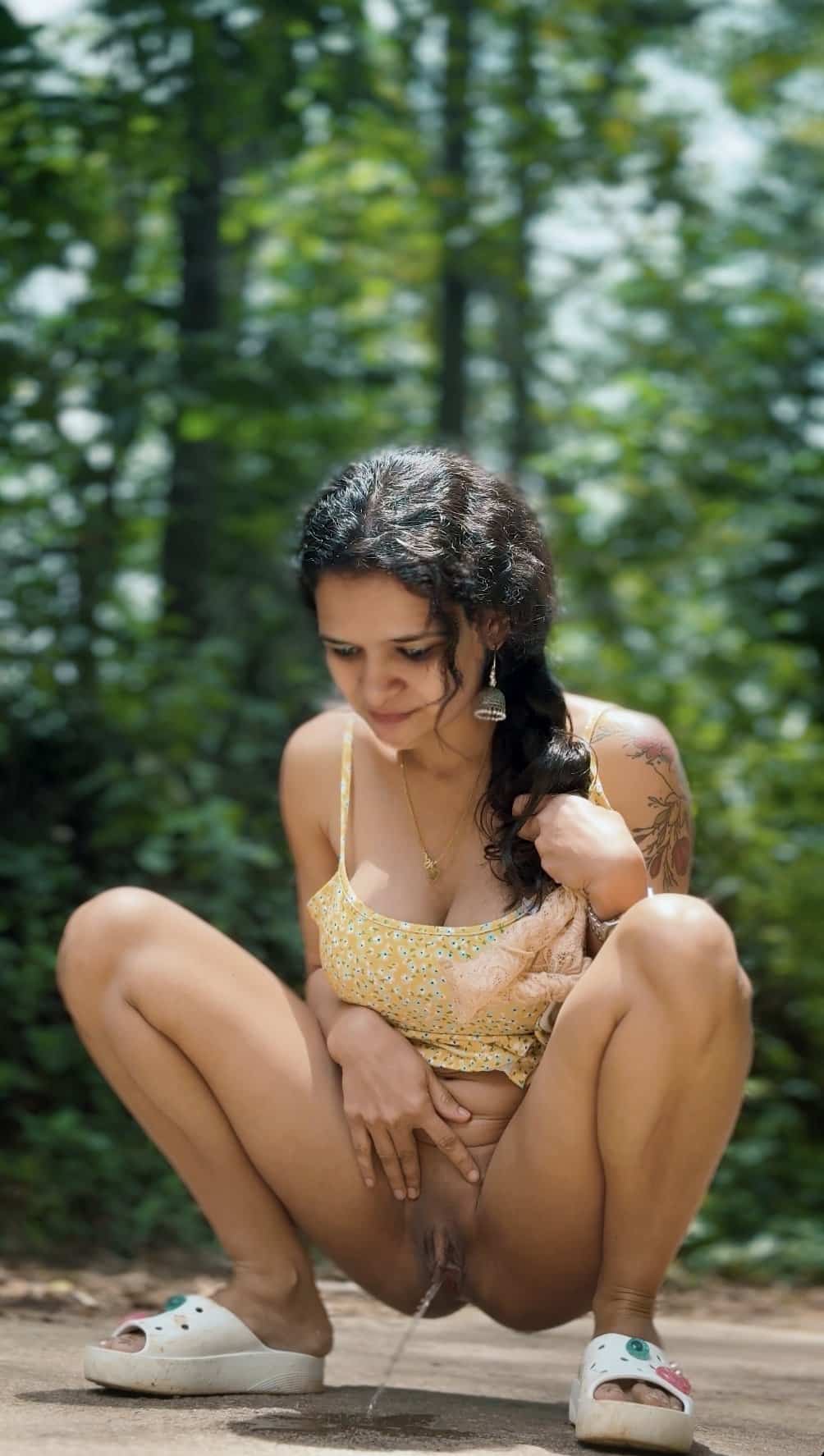 flashing video - Squatting in the Woods: A Natural Flash A woman squats outdoors, partially nude, exposing her natural bush and urinating. Her confident pose and focused expression highlight her comfort in the wild... - Bitch Flashing Pics