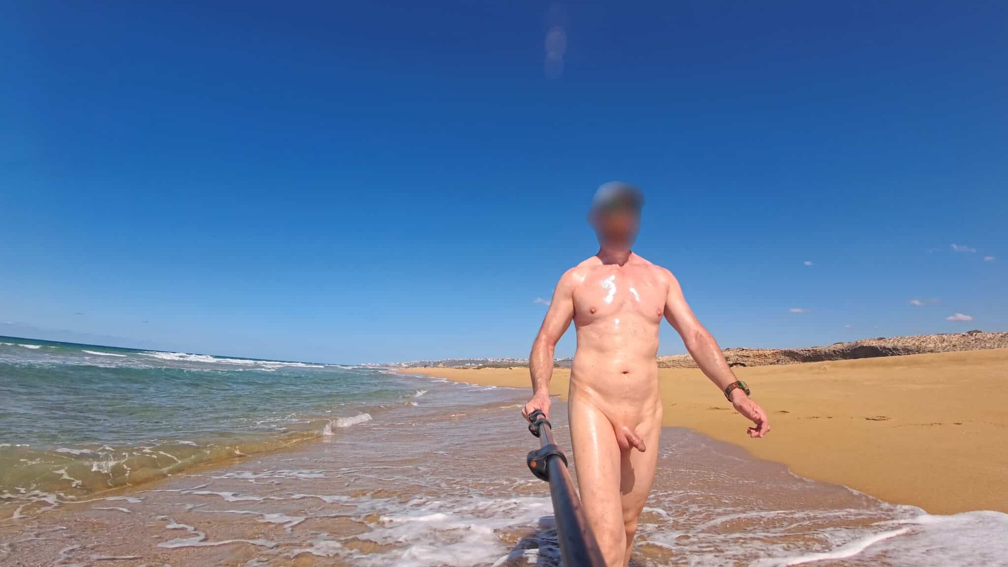 nude teen sticksm - Naked Stroll: Unofficial Nude Beach Encounter A man captures a selfie at an unofficial nude beach, showcasing public nudity with a watch on his wrist and a selfie stick in hand. - Dick Flash Pics