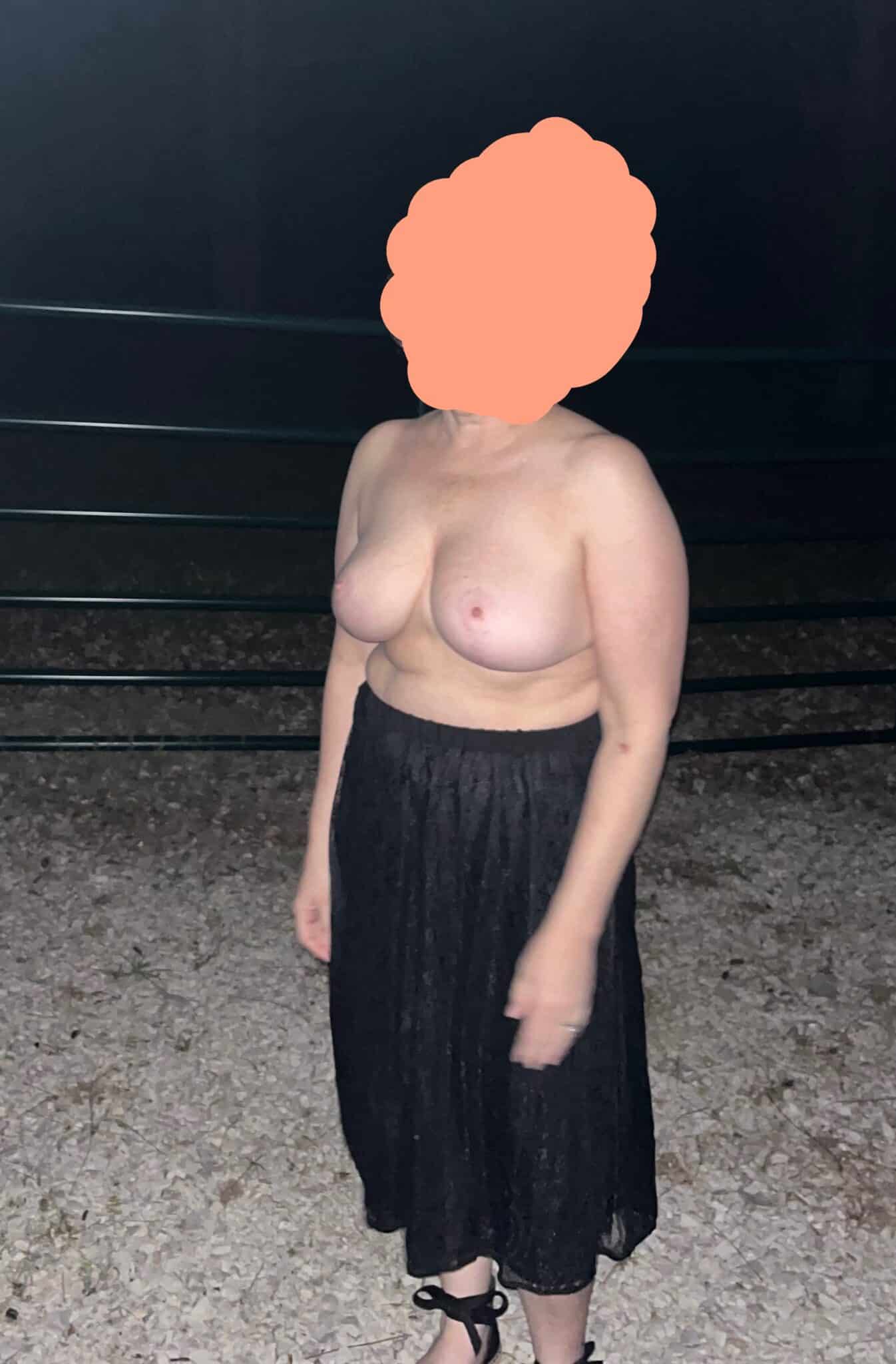 big buts flash - Who’s the MILF Flashing Her Boobs in Public? A MILF stands outdoors, topless in a black lace skirt, flashing her large, natural breasts near dark panels. Her confidence is palpable, owning her sexuality... - Boobs Flash Pics