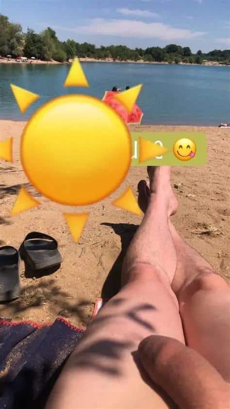 Dick Flash Pics: Teen Flashes His Thighs at Nudist Beach A teen at a nudist beach flashes his thighs, pulling down his shorts to reveal sun-kissed skin and dark leg hair. The casual setting includes a blue towel an...