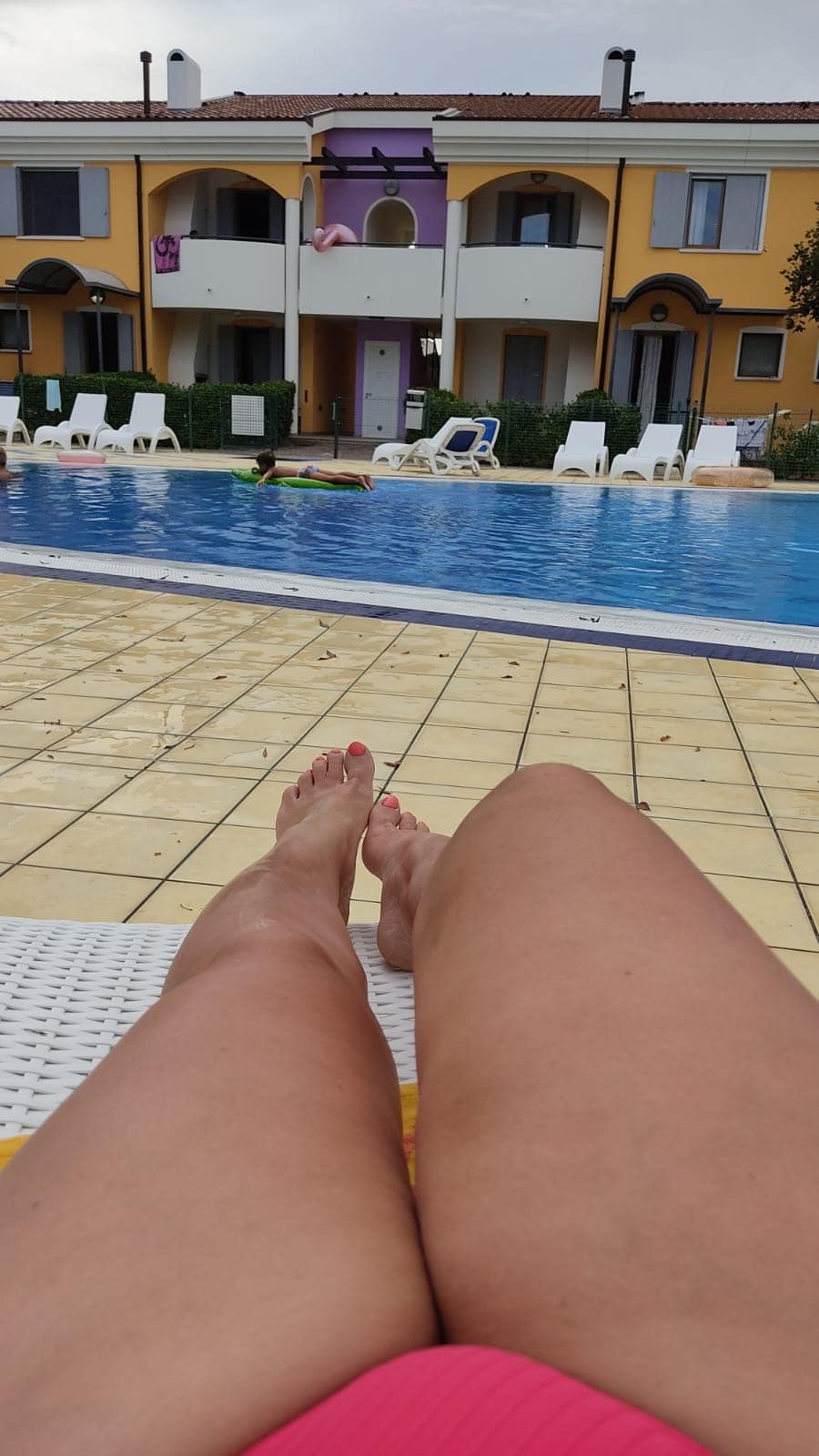 Hotwife Pics: Poolside Tease: Hotwife Sunbathing A hotwife sunbathing poolside in a pink bikini, exuding confidence and allure. Smooth thighs and a tantalizing glimpse of her curves draw attention.