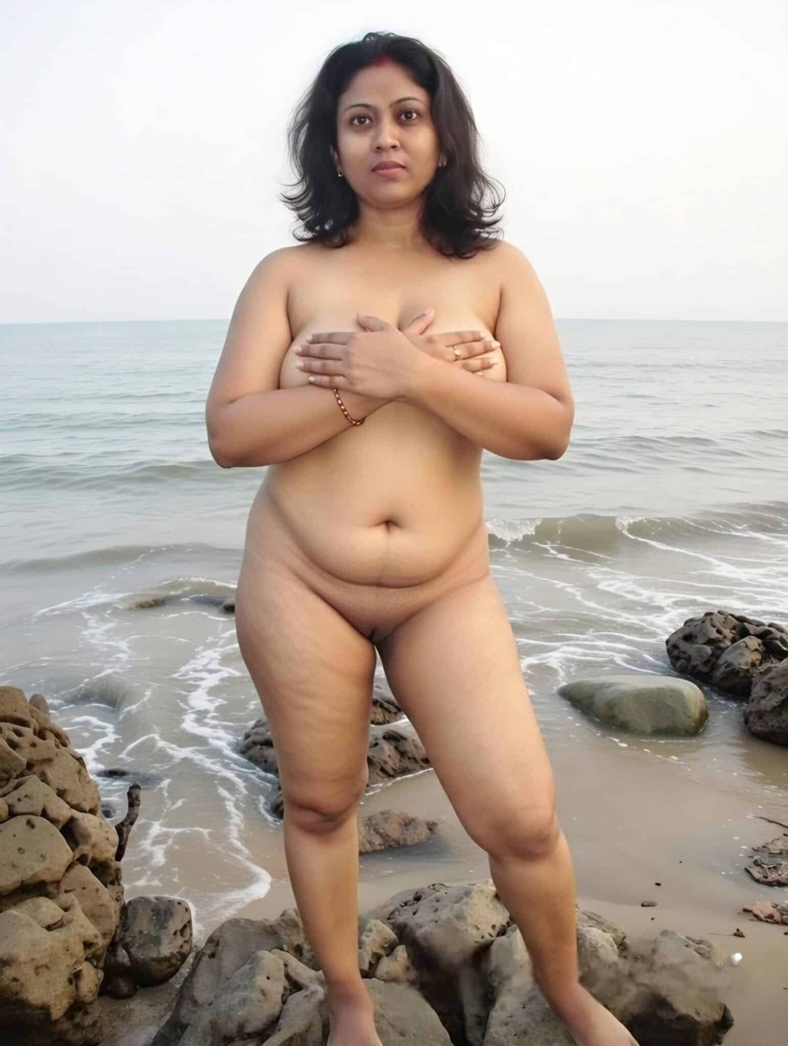 Bitch Flashing Pics: Mature Woman Flashing on the Beach Mature woman flashing on the beach, covering her breasts, with the ocean and rocks in the background.