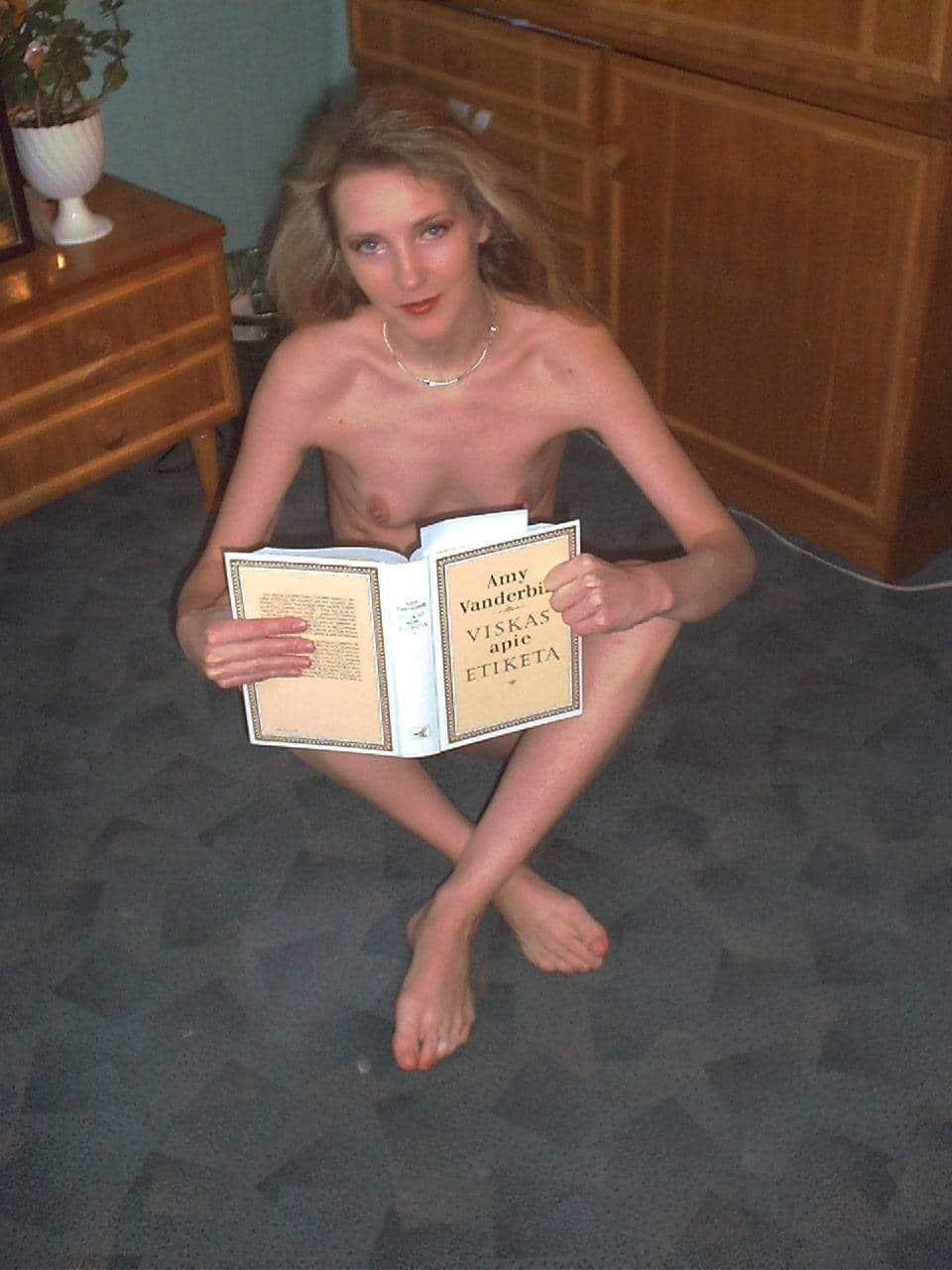 mumuye beautiful girls picture - Lithuanian Vitalija: Mature Flashing Pics A mature woman flashes in a bedroom setting, holding a book in front of her nude body, with a neutral expression and direct gaze. - Hotwife Pics