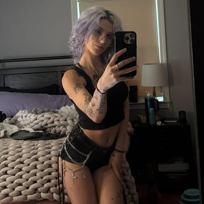 Paige in relaxed setting with visible nipple piercings
